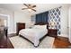 Spacious bedroom with a ceiling fan, hardwood floors, and a patterned rug at 513 Cutler St, Raleigh, NC 27603