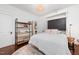 Bright bedroom featuring a built-in murphy bed, wood floors, and decorative shelving at 513 Cutler St, Raleigh, NC 27603