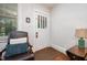 Inviting entryway featuring a decorative glass door, wood floors, and a comfortable chair at 513 Cutler St, Raleigh, NC 27603
