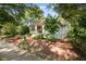 A charming home with a brick staircase, a cozy porch, and lush landscaping, blending seamlessly with its surroundings at 513 Cutler St, Raleigh, NC 27603