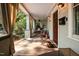 Charming porch with wooden flooring, comfortable seating, hanging curtains, and a welcoming atmosphere at 513 Cutler St, Raleigh, NC 27603
