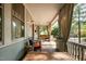 Inviting front porch featuring wood furniture, hanging curtains, and a relaxing ambiance for outdoor enjoyment at 513 Cutler St, Raleigh, NC 27603