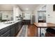 Open kitchen layout with stainless steel appliances, two-tone cabinets, and hardwood floors at 513 Cutler St, Raleigh, NC 27603