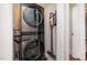 Convenient laundry area with a stacked washer and dryer, as well as a vacuum at 513 Cutler St, Raleigh, NC 27603