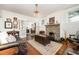 Elegant living room featuring hardwood floors, a stone fireplace, and a cozy seating arrangement at 513 Cutler St, Raleigh, NC 27603