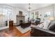 Cozy living room featuring a stone fireplace, hardwood floors, and classic decor at 513 Cutler St, Raleigh, NC 27603