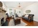 Inviting living room featuring hardwood floors, a stone fireplace, and comfortable seating at 513 Cutler St, Raleigh, NC 27603