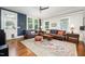 Cozy living room with leather sofas, hardwood floors, and ample natural light at 513 Cutler St, Raleigh, NC 27603