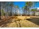 Spacious backyard surrounded by tall trees and natural foliage, perfect for outdoor activities at 5148 Glen Creek Trl, Garner, NC 27529