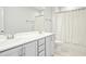 Bright bathroom with dual sinks, gray cabinetry, and a shower with a white curtain at 5148 Glen Creek Trl, Garner, NC 27529
