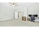 Spacious bedroom with a ceiling fan and windows, featuring a desk and gaming setup at 5148 Glen Creek Trl, Garner, NC 27529