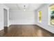 Elegant dining room featuring hardwood floors, wainscoting, and a view of the front yard at 5148 Glen Creek Trl, Garner, NC 27529