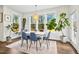 Sunlit dining area with large windows and stylish furnishings at 5148 Glen Creek Trl, Garner, NC 27529