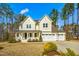 Charming two-story home featuring a welcoming front porch and a spacious three-car garage at 5148 Glen Creek Trl, Garner, NC 27529