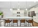Modern kitchen island with quartz countertops, stainless steel appliances, and pendant lighting at 5148 Glen Creek Trl, Garner, NC 27529