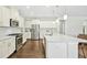 Bright, open kitchen with stainless appliances, an island, and wooden floors at 5148 Glen Creek Trl, Garner, NC 27529
