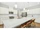 Bright kitchen featuring a large island with seating, stainless steel appliances, and custom cabinetry at 5148 Glen Creek Trl, Garner, NC 27529