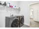 Convenient laundry room with modern Samsung washer and dryer units and ample shelving at 5148 Glen Creek Trl, Garner, NC 27529
