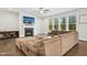 Relaxing living area with a fireplace, TV, and a large sectional couch facing bright windows at 5148 Glen Creek Trl, Garner, NC 27529
