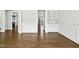 Open-concept living space with hardwood floors and ample natural light, leading to other rooms at 5148 Glen Creek Trl, Garner, NC 27529