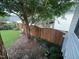 Fenced backyard with a small garden area and well maintained lawn at 526 Cardena School Rd, Fuquay Varina, NC 27526