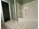Bathroom view featuring a tiled floor, a standard bathtub and shower, and an open doorway to a walk-in closet at 526 Cardena School Rd, Fuquay Varina, NC 27526