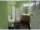 Stylish bathroom featuring a glass-enclosed shower, modern vanity, and distinctive black marble flooring at 526 Cardena School Rd, Fuquay Varina, NC 27526