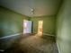 Bedroom showing carpet, neutral-painted walls, and a view of an open doorway at 526 Cardena School Rd, Fuquay Varina, NC 27526