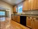 Charming kitchen featuring wooden cabinets, complementing countertops and hardwood floors at 526 Cardena School Rd, Fuquay Varina, NC 27526