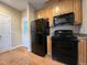 Kitchen view showing the black appliances and complementing hardwood floors at 526 Cardena School Rd, Fuquay Varina, NC 27526