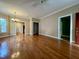 Open-concept living room featuring hardwood floors, chandelier lighting, and natural light at 526 Cardena School Rd, Fuquay Varina, NC 27526