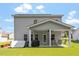 Backyard featuring a covered patio with an outdoor ceiling fan, table and seating at 534 Lionheart Ln, Sanford, NC 27330