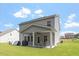 Backyard featuring a covered patio with an outdoor ceiling fan, table and seating at 534 Lionheart Ln, Sanford, NC 27330