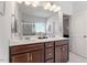 Bathroom with double sink vanity, framed mirror, and tile shower at 534 Lionheart Ln, Sanford, NC 27330