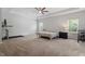 Spacious main bedroom with ceiling fan, carpet, recessed lighting, and sitting area at 534 Lionheart Ln, Sanford, NC 27330