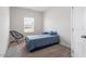 Neutral bedroom with a single bed, natural light from the window, and a woven chair at 534 Lionheart Ln, Sanford, NC 27330