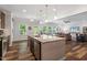 Open-concept kitchen with a large island, stainless steel appliances, and a view of the cozy living room at 534 Lionheart Ln, Sanford, NC 27330