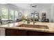Close up view of a kitchen island with sink, granite counters, and views to the great room at 534 Lionheart Ln, Sanford, NC 27330