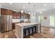 Spacious kitchen island with granite countertops and seating, seamlessly connecting to the adjacent stainless steel appliances at 534 Lionheart Ln, Sanford, NC 27330