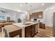 Open concept kitchen with granite counters, stainless appliances, pendant lights, and hardwood floors at 534 Lionheart Ln, Sanford, NC 27330
