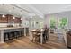 Open kitchen and dining area features a large island, modern appliances, and hardwood flooring at 534 Lionheart Ln, Sanford, NC 27330