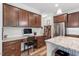 Gourmet kitchen featuring custom cabinetry, granite countertops, stainless steel appliances, and dedicated workspace at 534 Lionheart Ln, Sanford, NC 27330