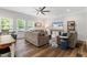 Inviting living room with a ceiling fan, large windows, and comfortable seating arrangement at 534 Lionheart Ln, Sanford, NC 27330