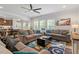 Spacious living room featuring hardwood floors, comfortable sofas, and a view into the kitchen at 534 Lionheart Ln, Sanford, NC 27330