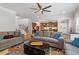 Spacious living room featuring hardwood floors, comfortable sofas, and a view into the kitchen and staircase at 534 Lionheart Ln, Sanford, NC 27330