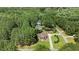 Serene aerial shot of a residence nestled among mature trees, showcasing privacy and natural beauty at 55 Fleming Forest Dr, Youngsville, NC 27596