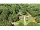 Overhead view of a home surrounded by lush forest, highlighting the property's privacy and seclusion at 55 Fleming Forest Dr, Youngsville, NC 27596