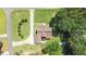 Stunning aerial view of a property showcasing a lush lawn, mature trees, and a red patio umbrella at 55 Fleming Forest Dr, Youngsville, NC 27596