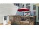 View of the wooden deck with an outdoor dining set and a red umbrella, perfect for outdoor entertaining at 55 Fleming Forest Dr, Youngsville, NC 27596