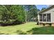 Expansive backyard featuring a lush green lawn, mature trees, and a wooden fence for added privacy at 55 Fleming Forest Dr, Youngsville, NC 27596
